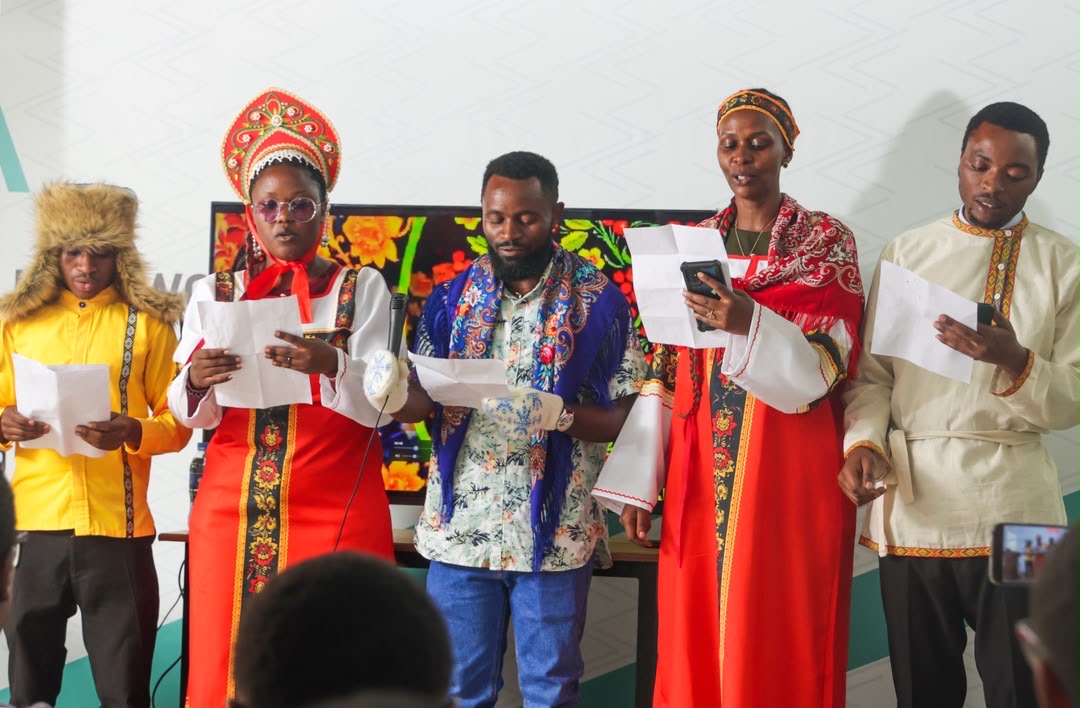 Performers in traditional Russian folk costume reading during Day One